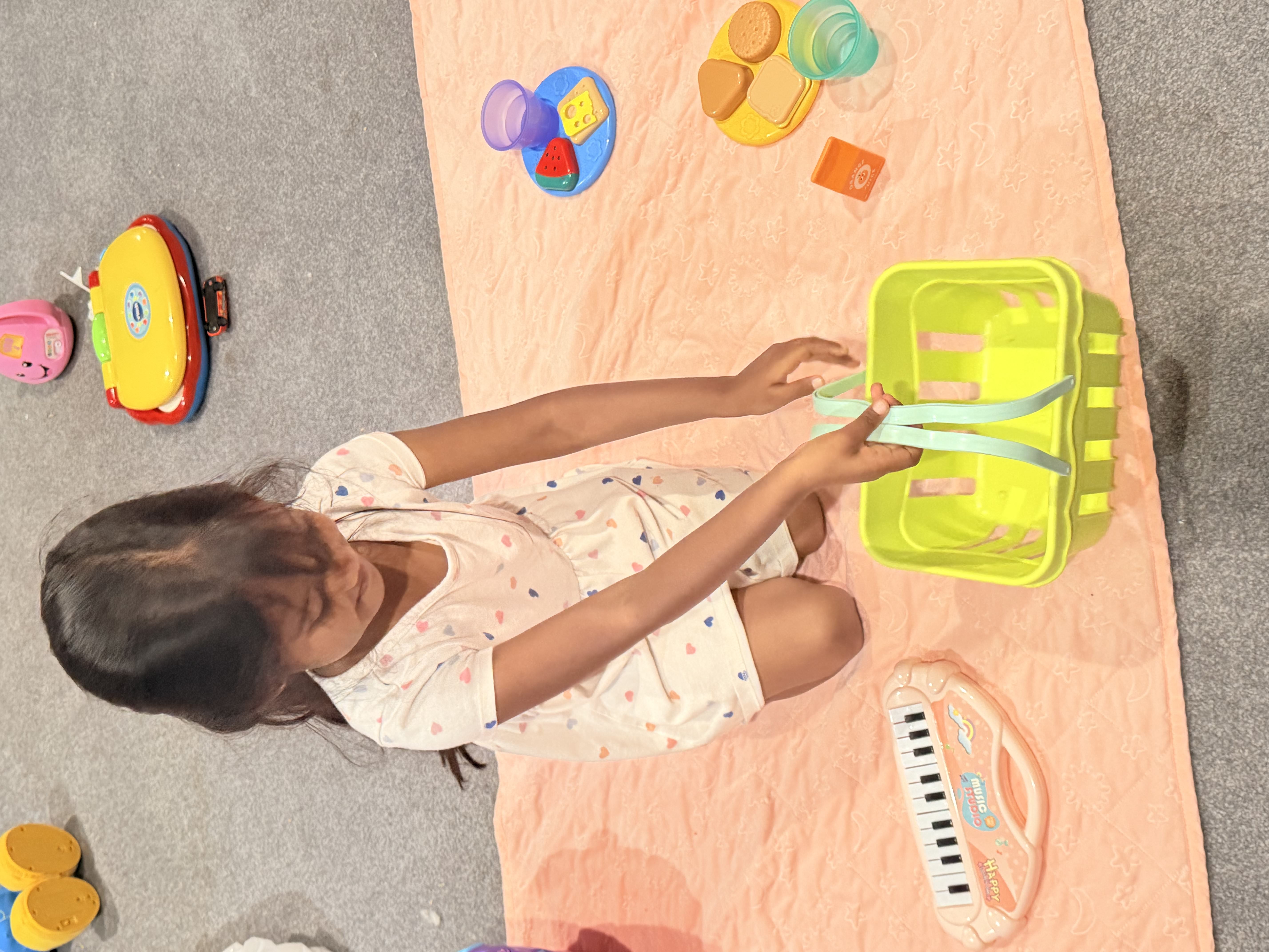 Girl playing with toys on mat