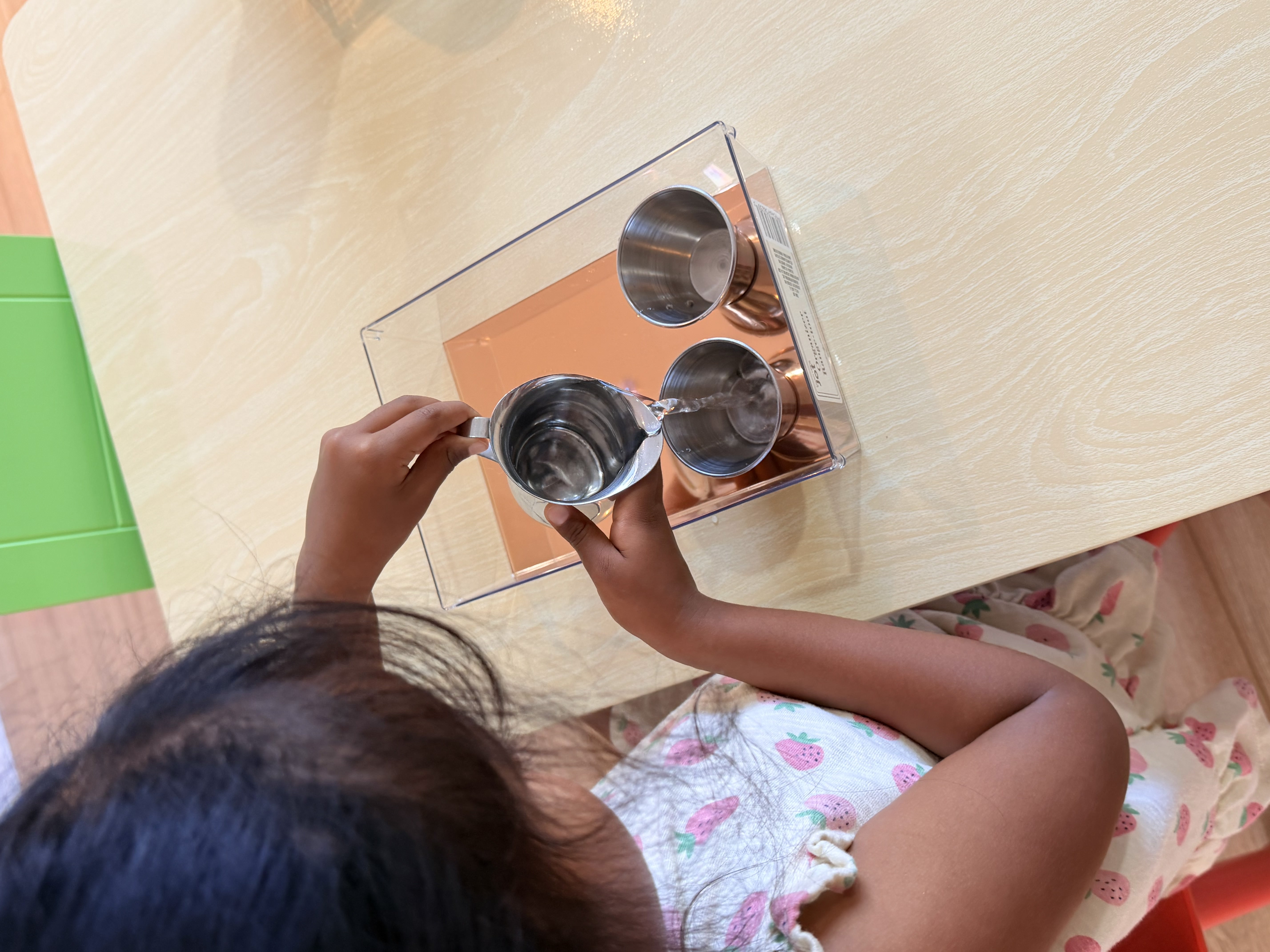 Girl with Montessori cups