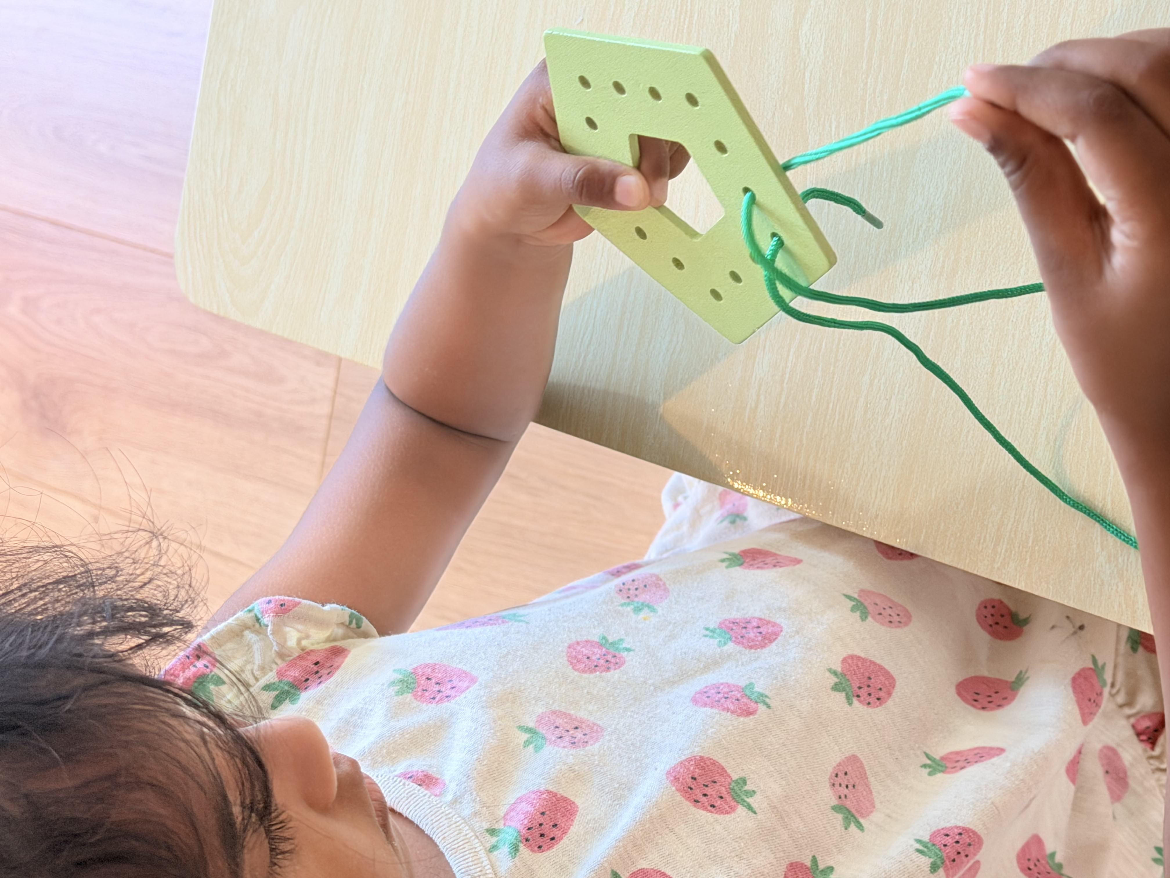 Child doing a lacing activity